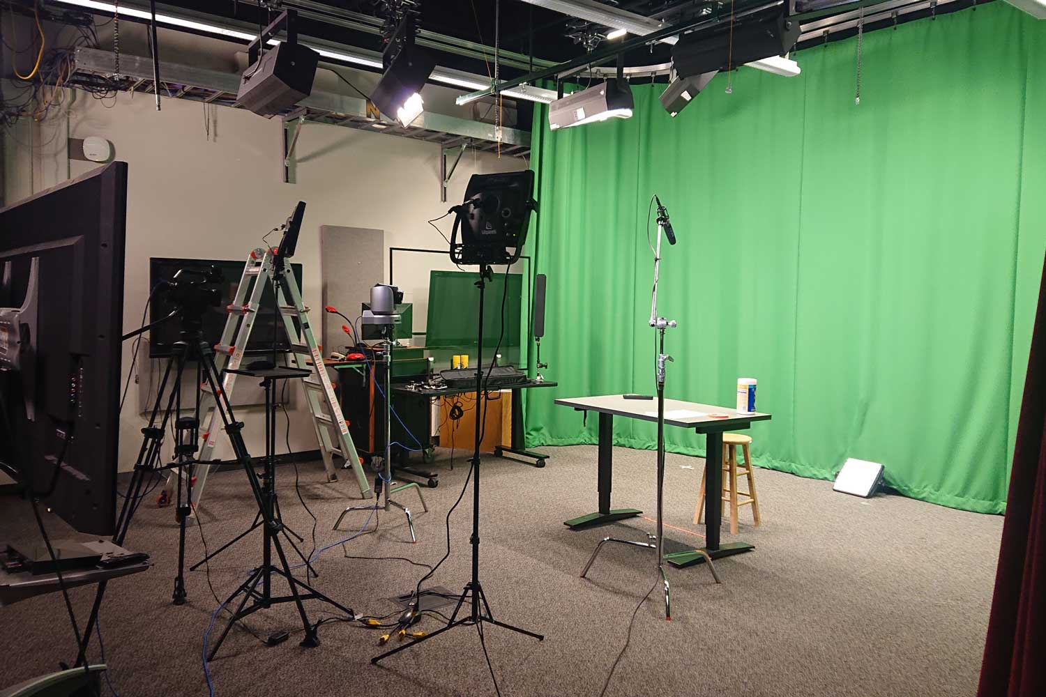 Photos of empty AMPS studio, with greenscreen, cameras, and furniture in view.